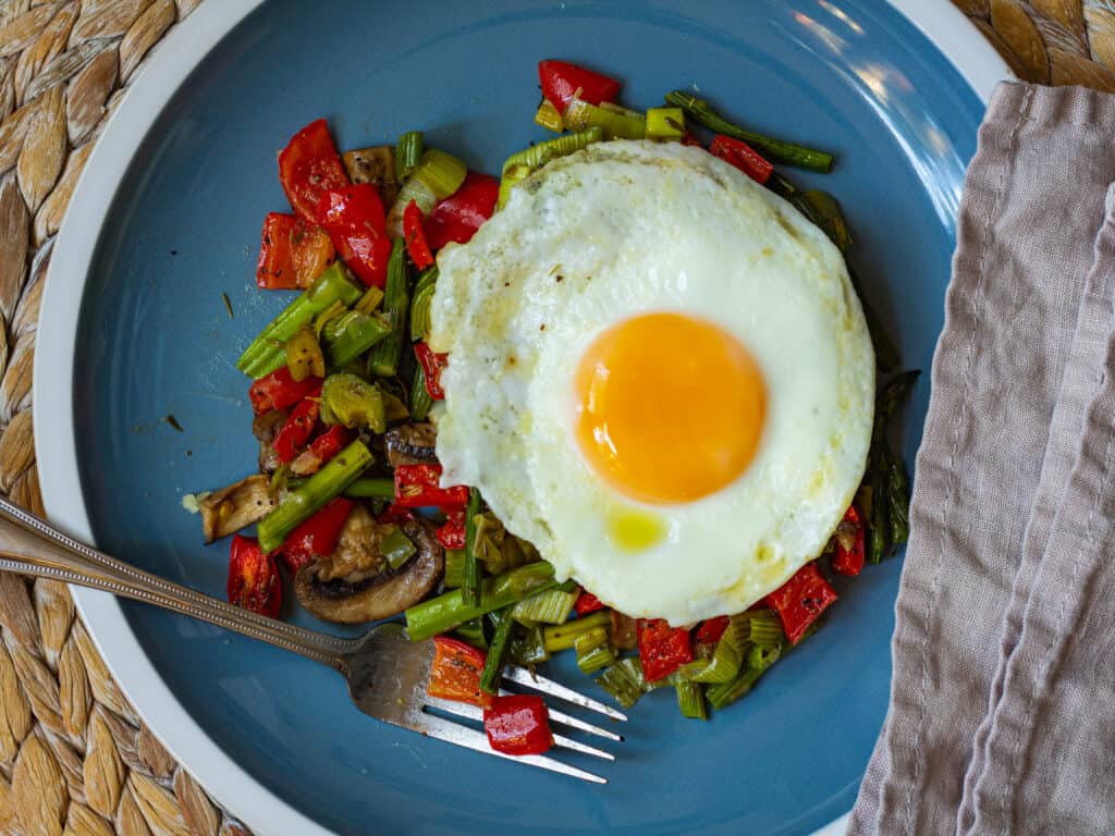 Vegetable hash with egg and fork