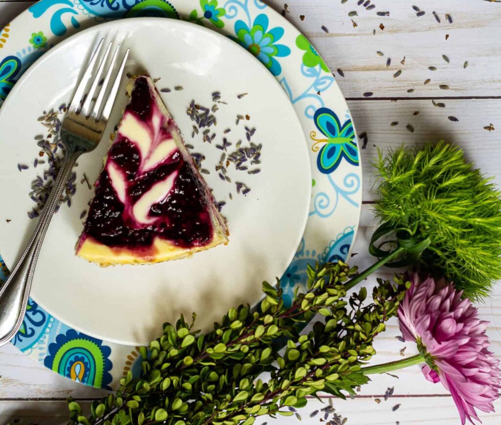 blackberry lavender cheesecake on a plate with a fork