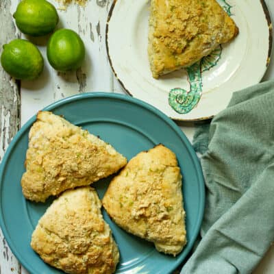 scones on a blue plate next to a white plate with a scone