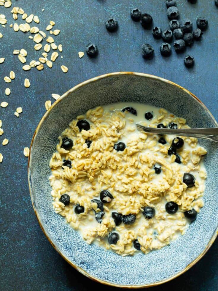 blueberry overnight oats in a blue bowl