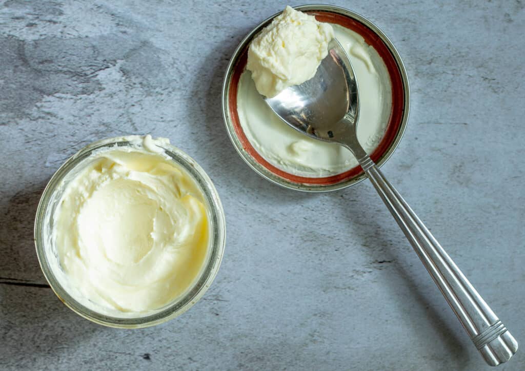 overhead photo of a jar of creme fraiche with a spoon