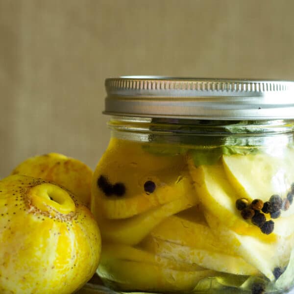 jar of lemon cucumbers next to lemon cucumbers