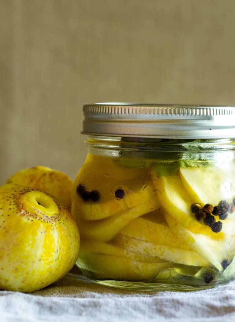jar of lemon cucumbers next to lemon cucumbers
