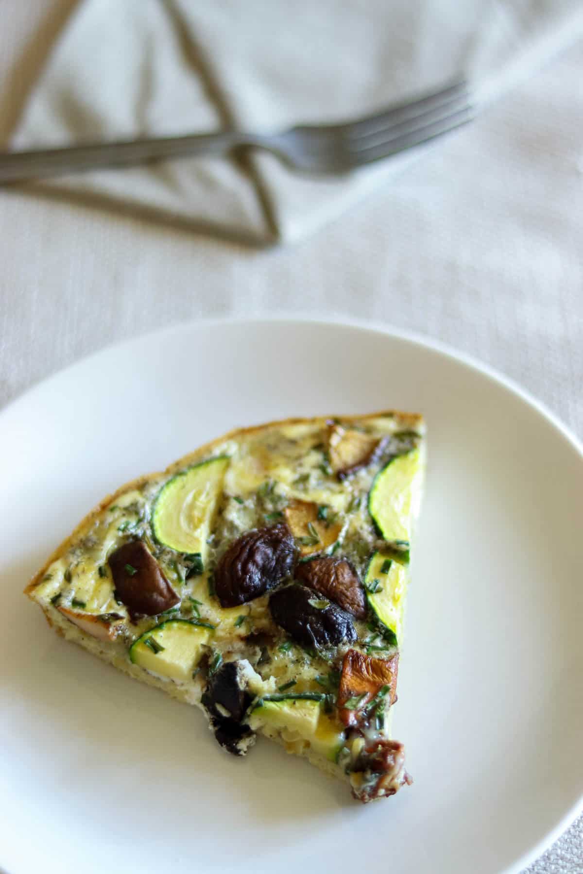 frittata slice on a white plate with a napkin.