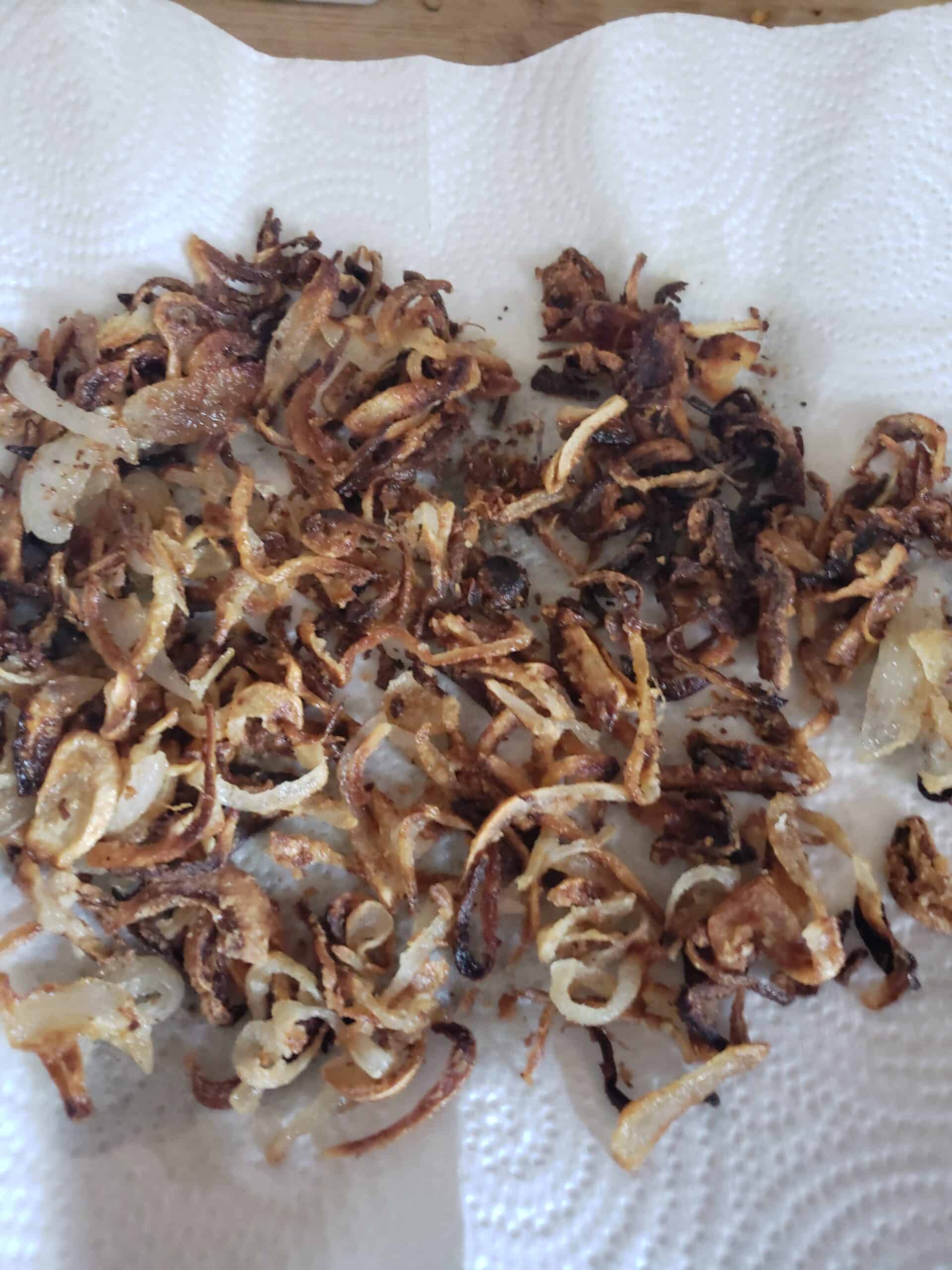 crispy fried shallots draining on a paper towel.