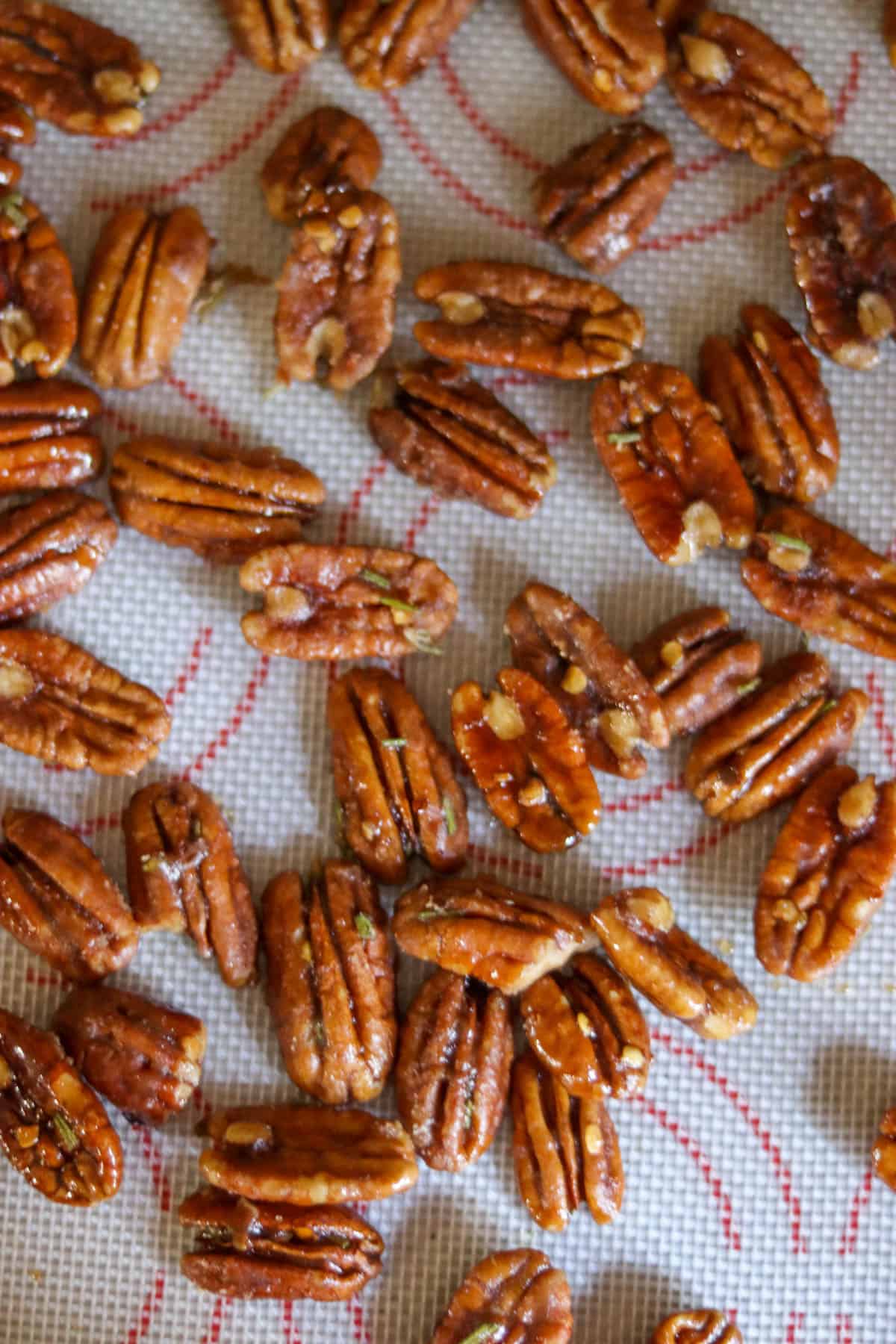 candied pecans on a silicone mat