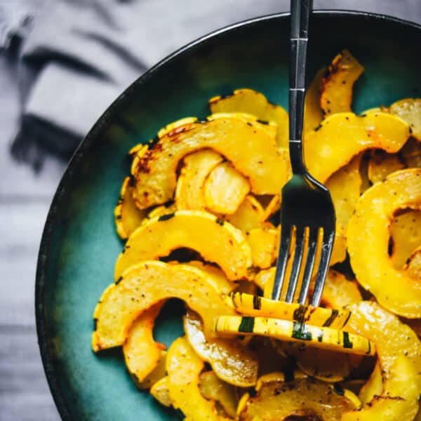 Delicata squash cooked in an air fryer in a blue bowl.
