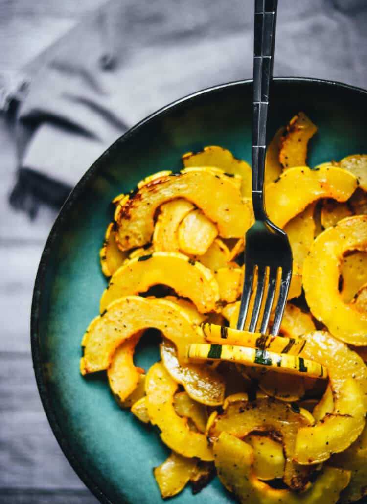 Delicata squash cooked in an air fryer in a blue bowl.
