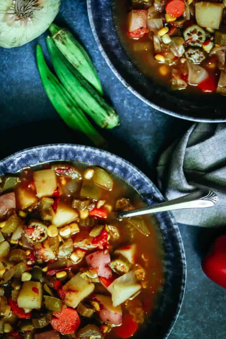 closeup of bowls of soup with fresh okra.