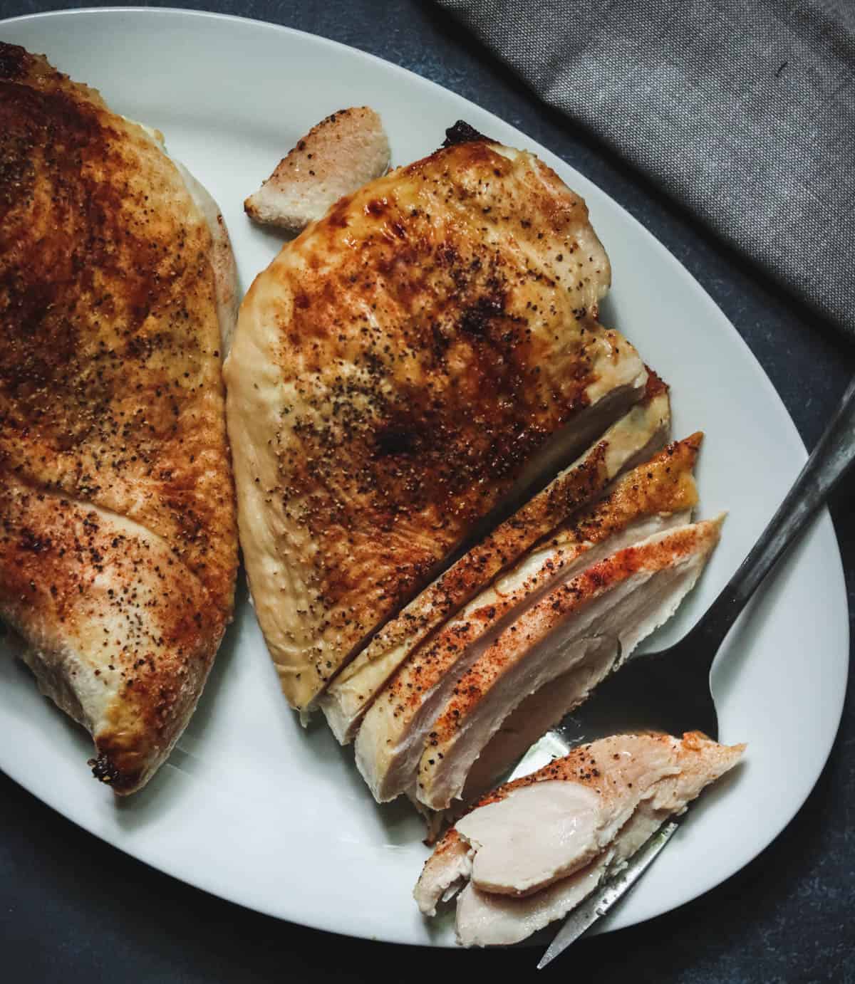 Roasted turkey breast with a fork.