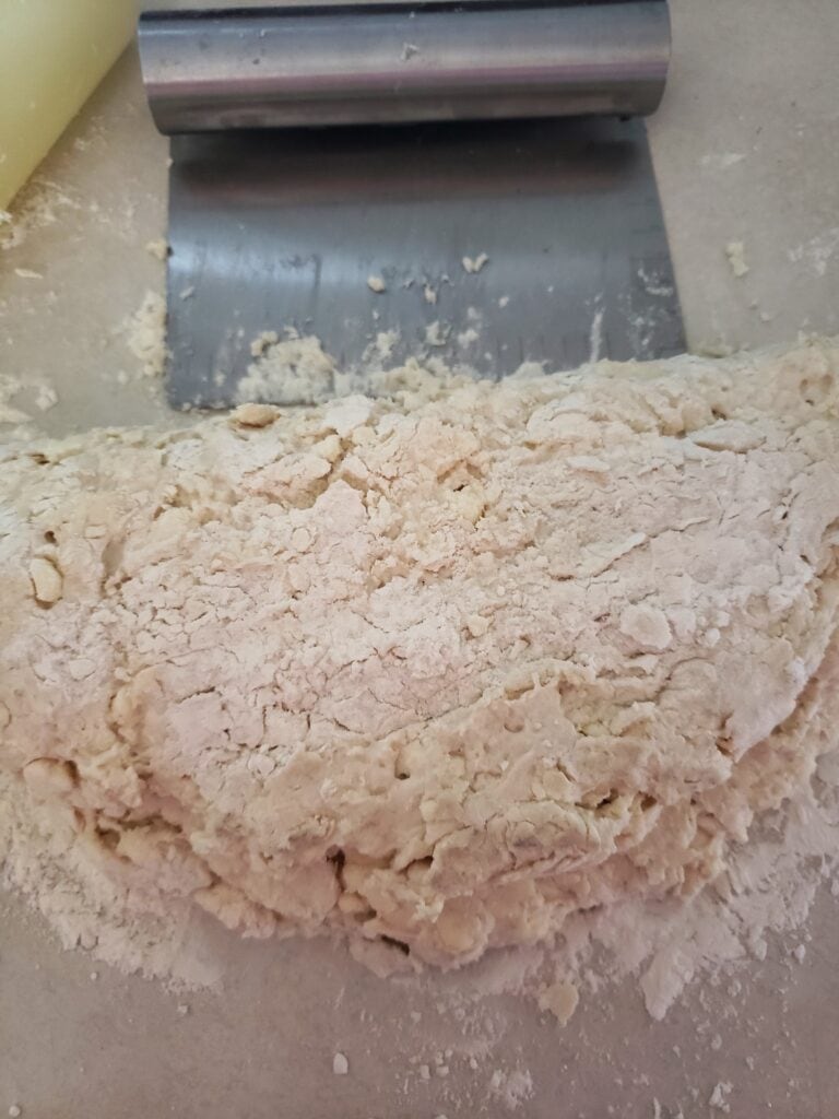 Folding the dough to create layers.