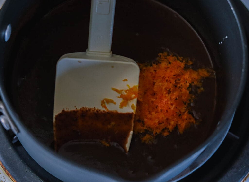 Adding the orange zest to the ganache.