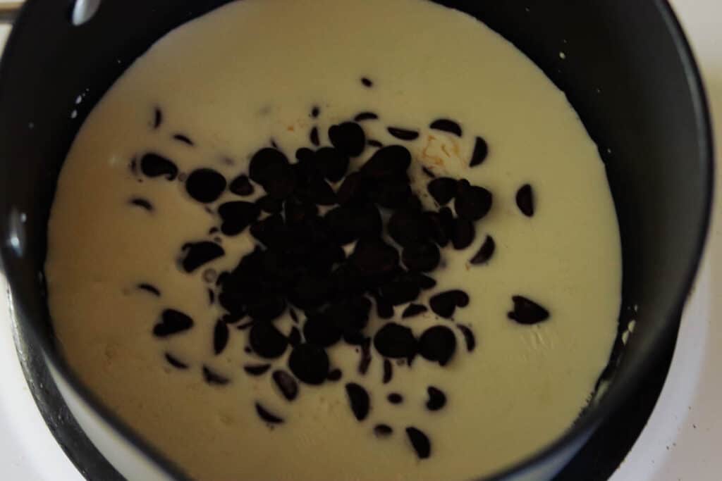 Chocolate chips added to cream to make the ganache.