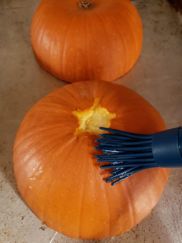 Brushing pumpkins with oil.