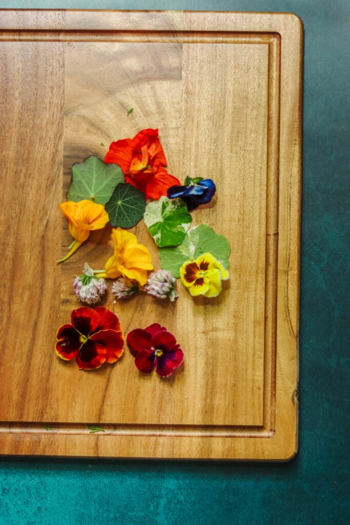 Edible flowers on a cutting board.
