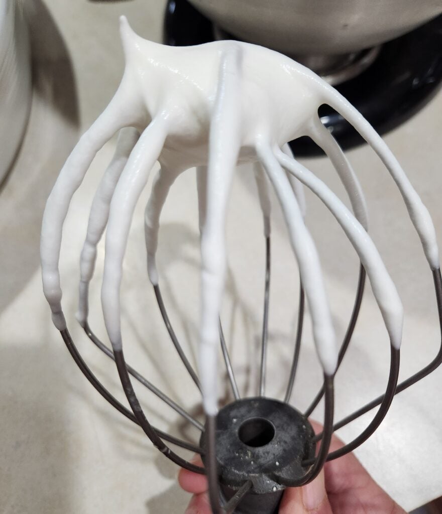 Whisk attachment with whipped cream.