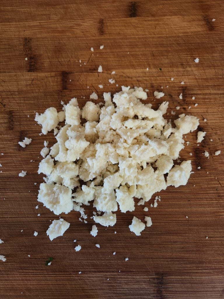 Queso fresco cheese on a cutting board.