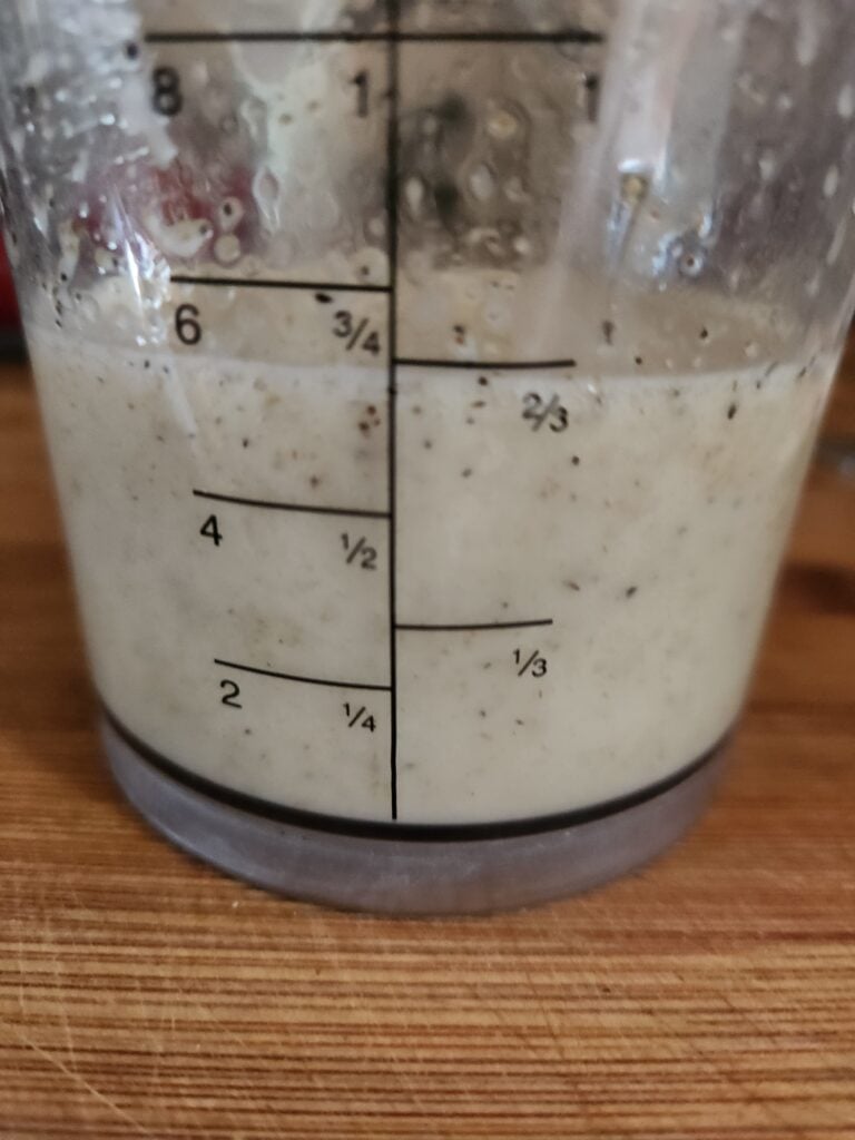 Dressing for charred corn salad in a blender cup.