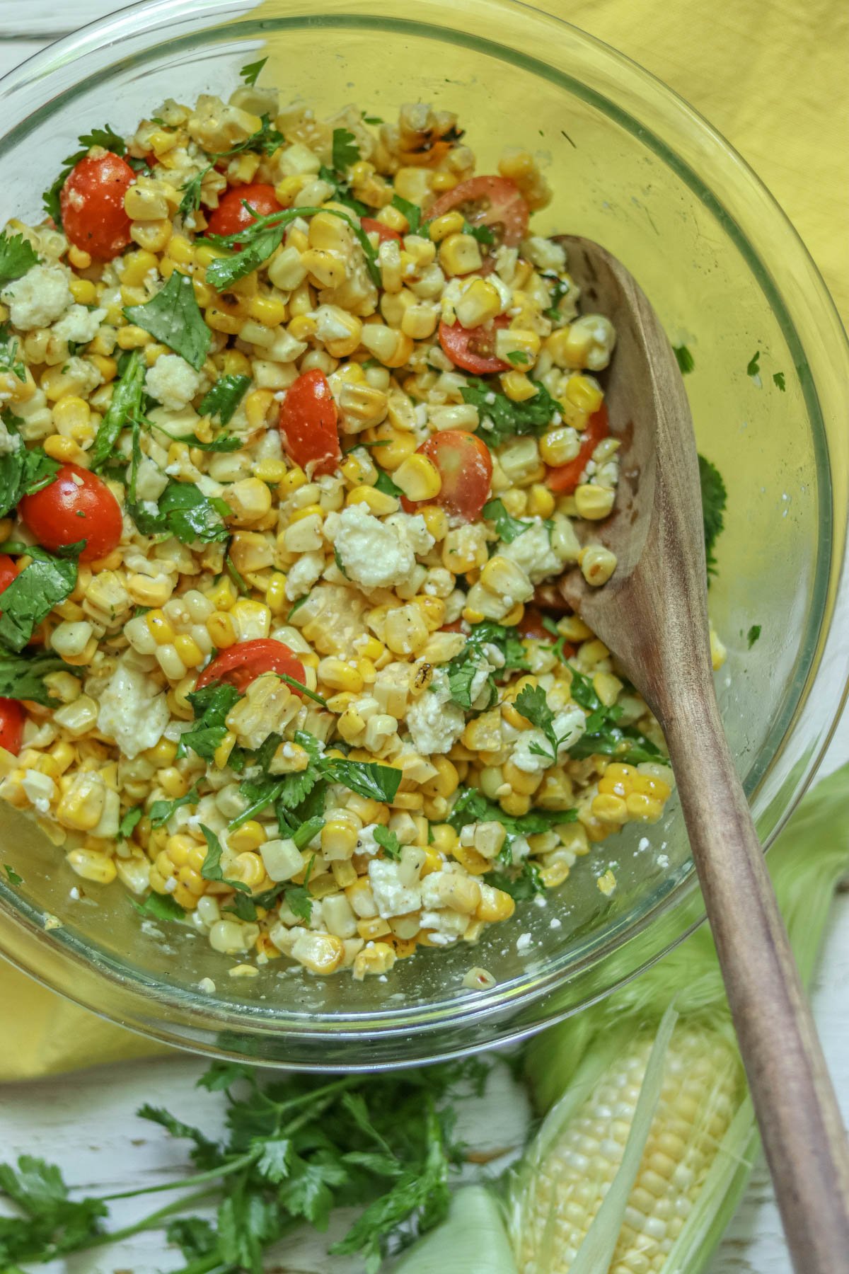 Corn salad in a large bowl on a yellow napkin.