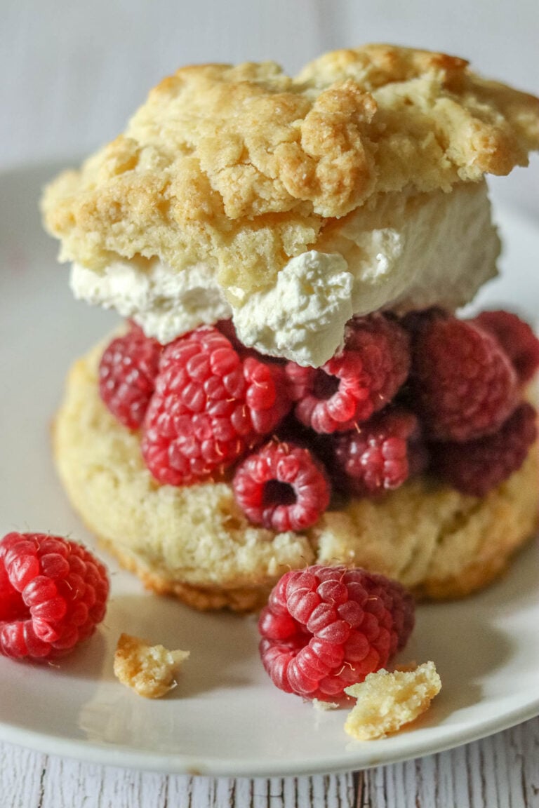 Easy Raspberry shortcake with whipped cream on a plate.