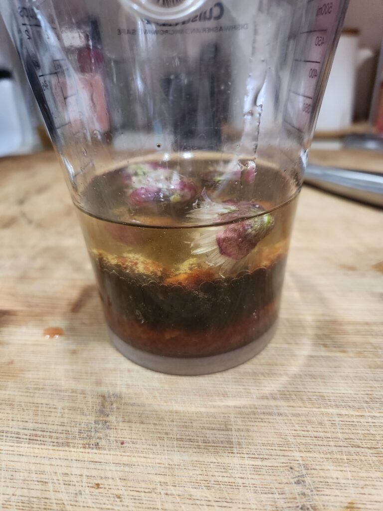 Strawberry vinaigrette ingredients in a blender cup.