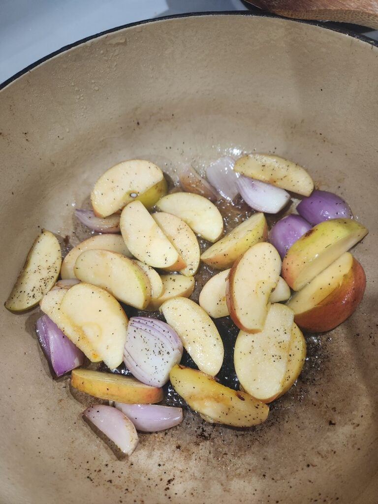 Shallots and apples in a dutch oven.