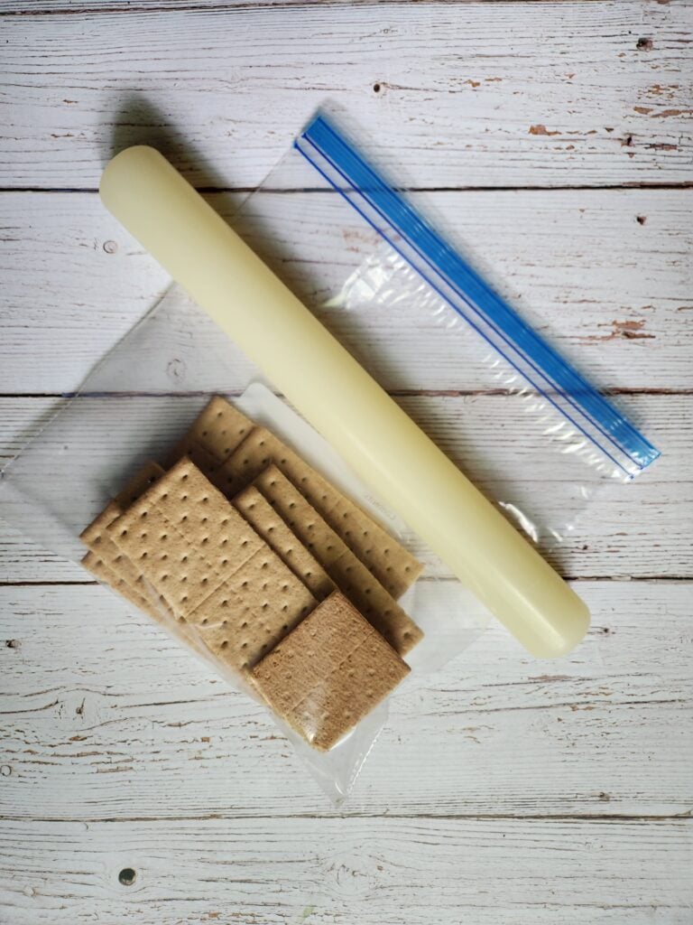 Graham crackers in a bag with a rolling pin.