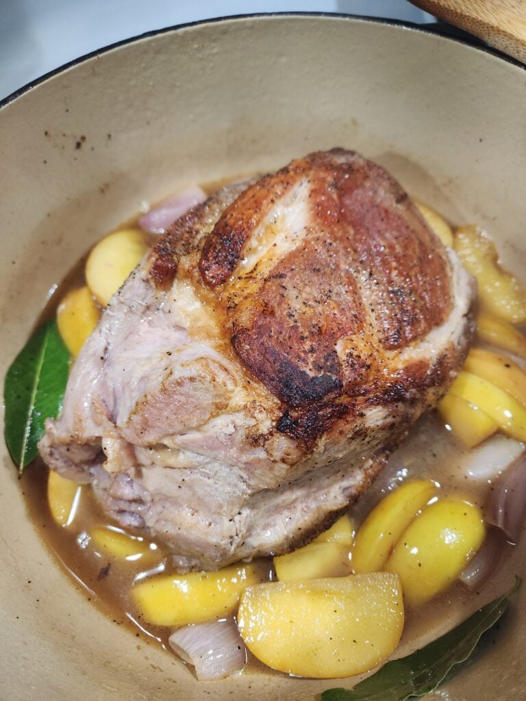 Pork roast in braising liquid.