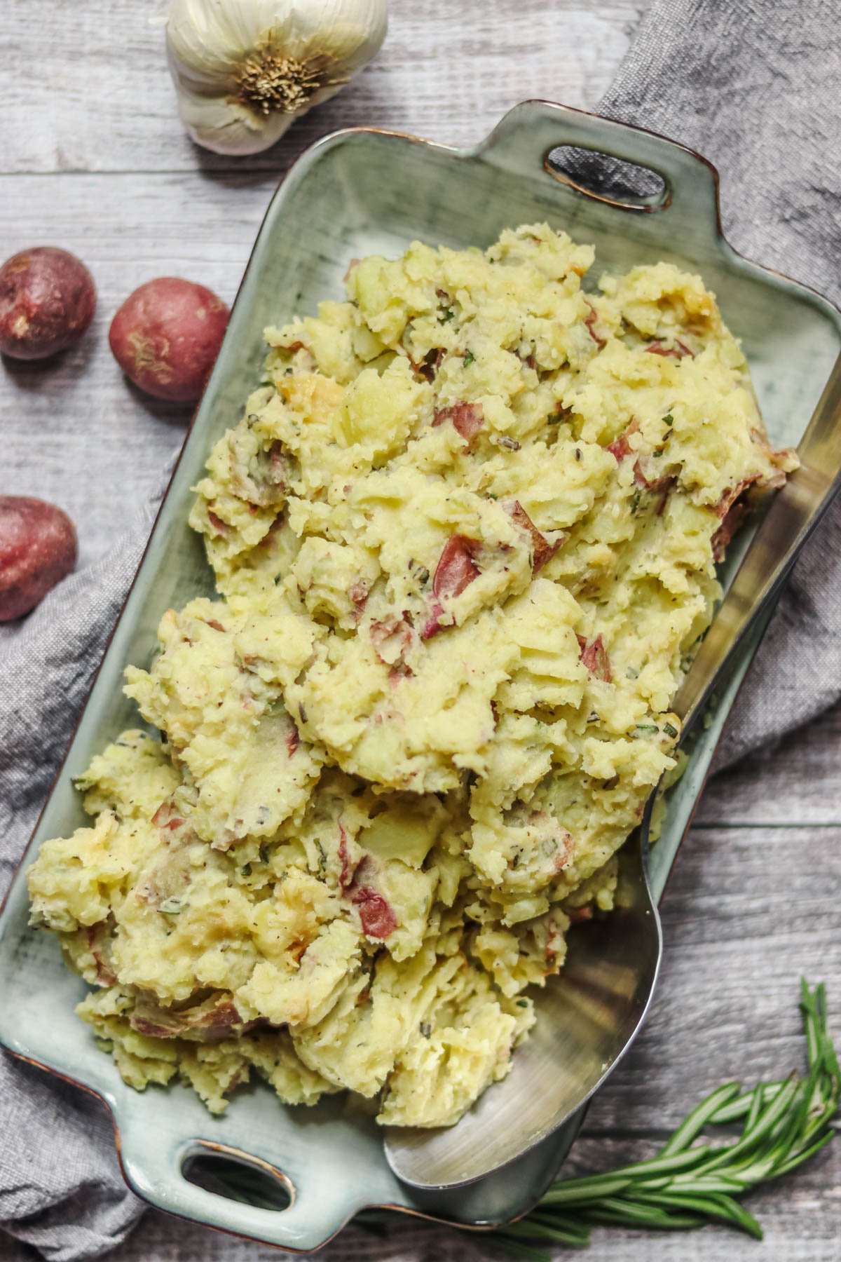 Roasted garlic mashed potatoes in an oblong shaped dish.