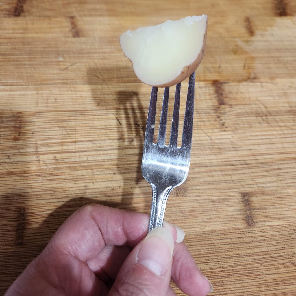Potato piece on a fork.