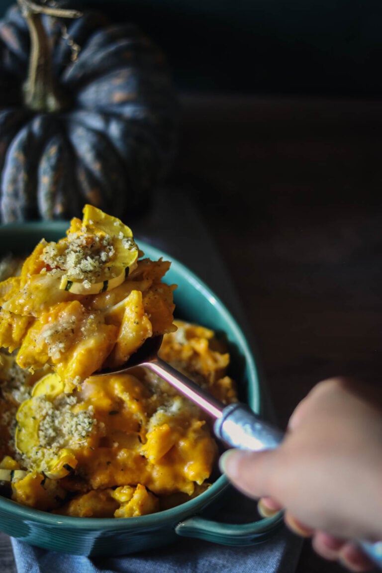 Winter squash mac and cheese being spooned from a dish.