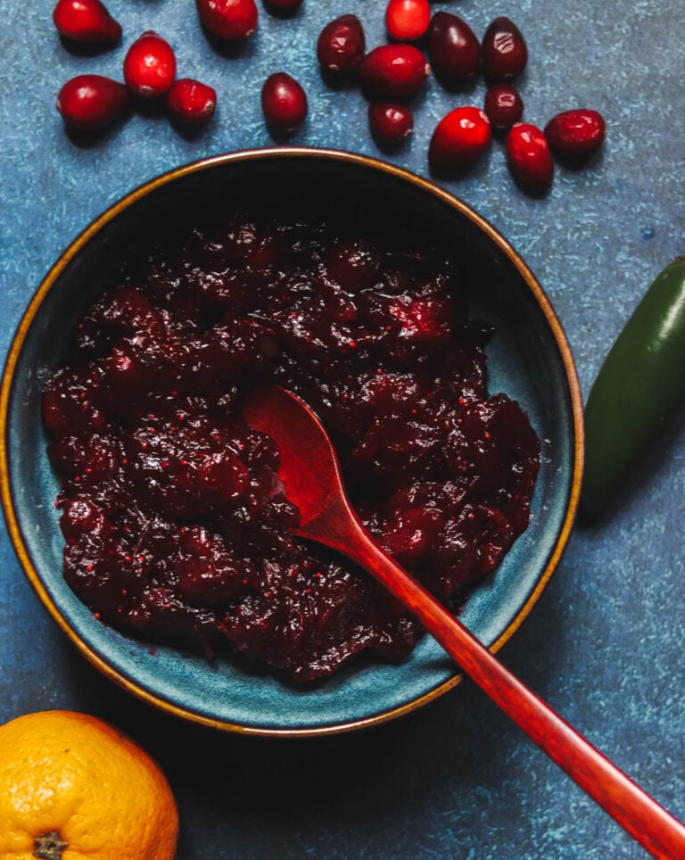 Cranberry Sauce With jalapeno in a bowl on a blue background.