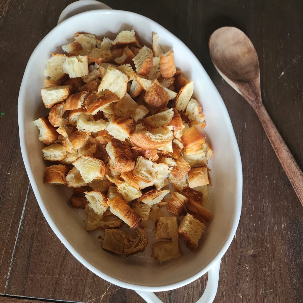 Croissant cubes in a casserole dish.