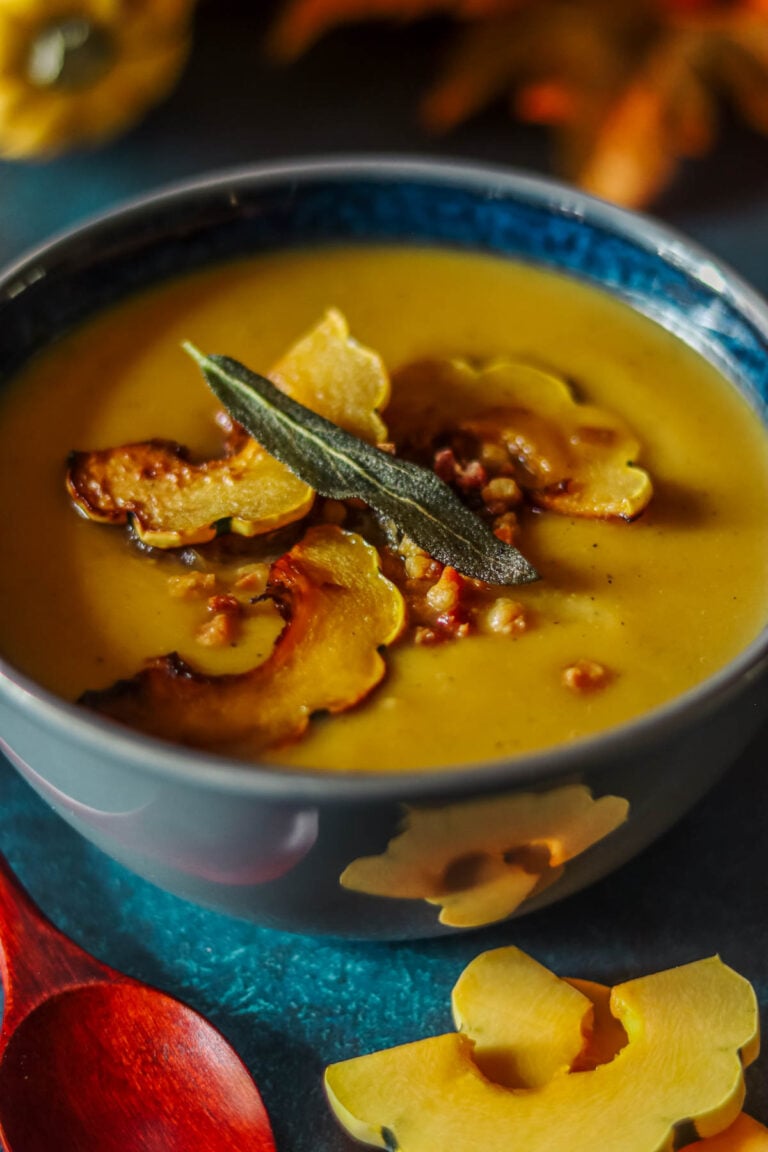 Squash soup in a gray and blue bowl.
