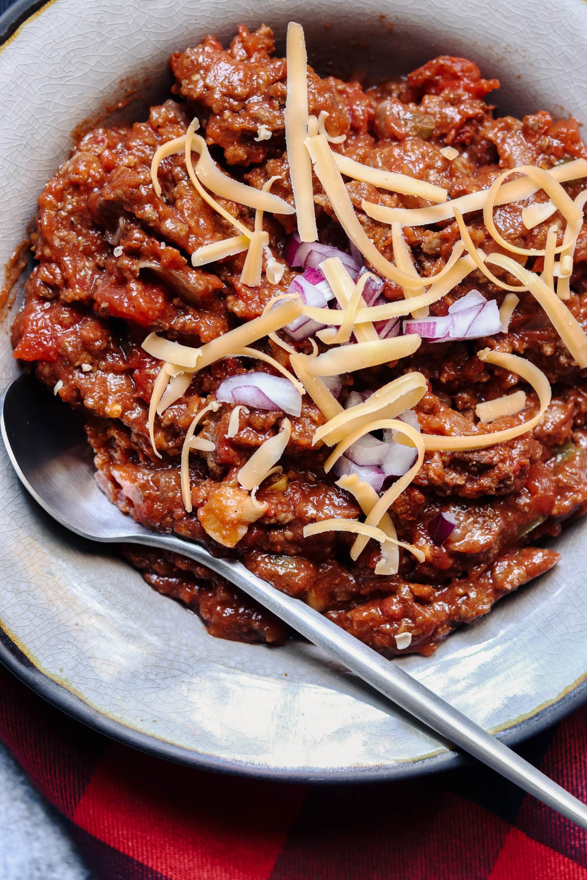 No bean slow cooker chili in a gray bowl with a silver spoon.
