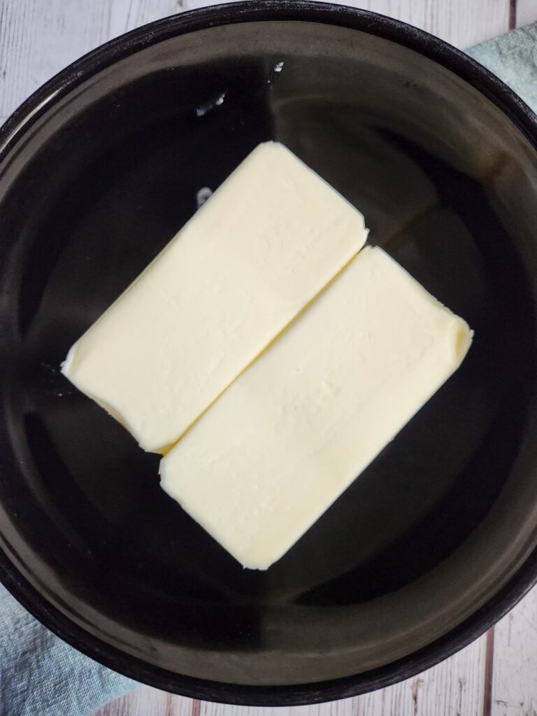Two sticks of butter in a bowl.
