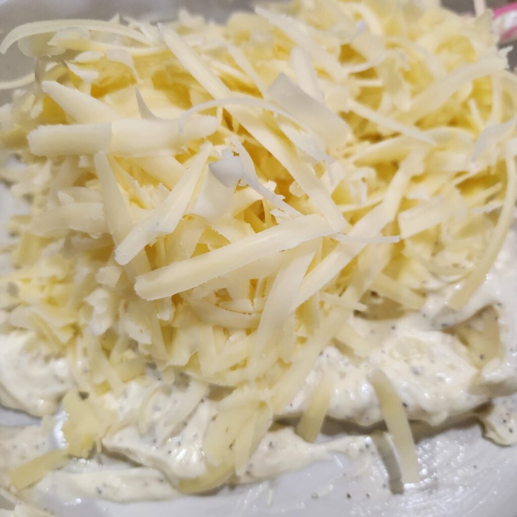 Add the shredded cheese to the baking dish.
