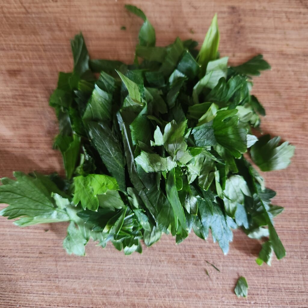 Chopped celery tops on a cutting board.